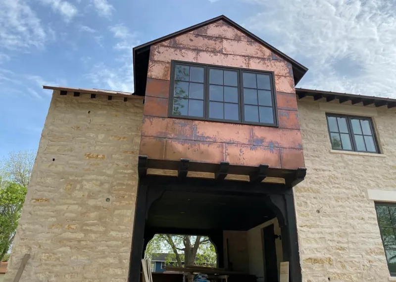 Copper metal panel facade on a stone building for Skylight Installation in Ferndale